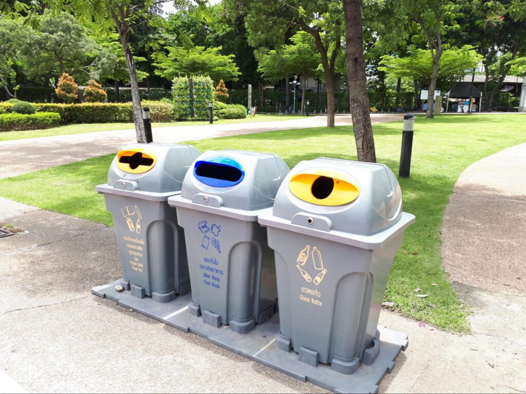 3 trash cans in the park