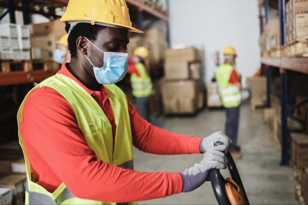 African warehouse worker with a face mask