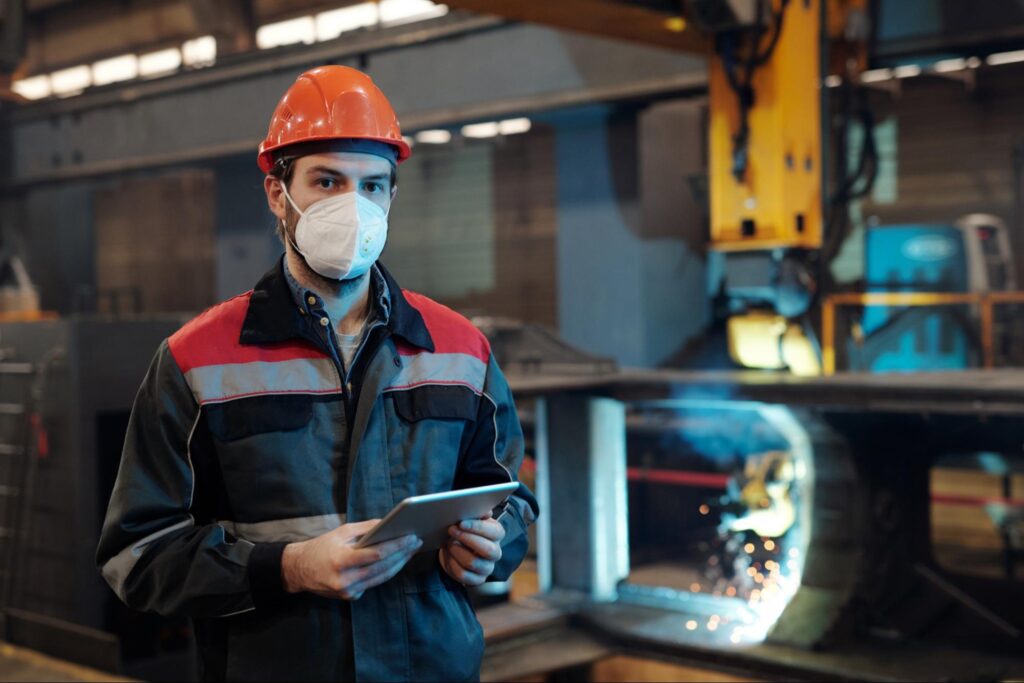 Contemporary factory worker with a tablet