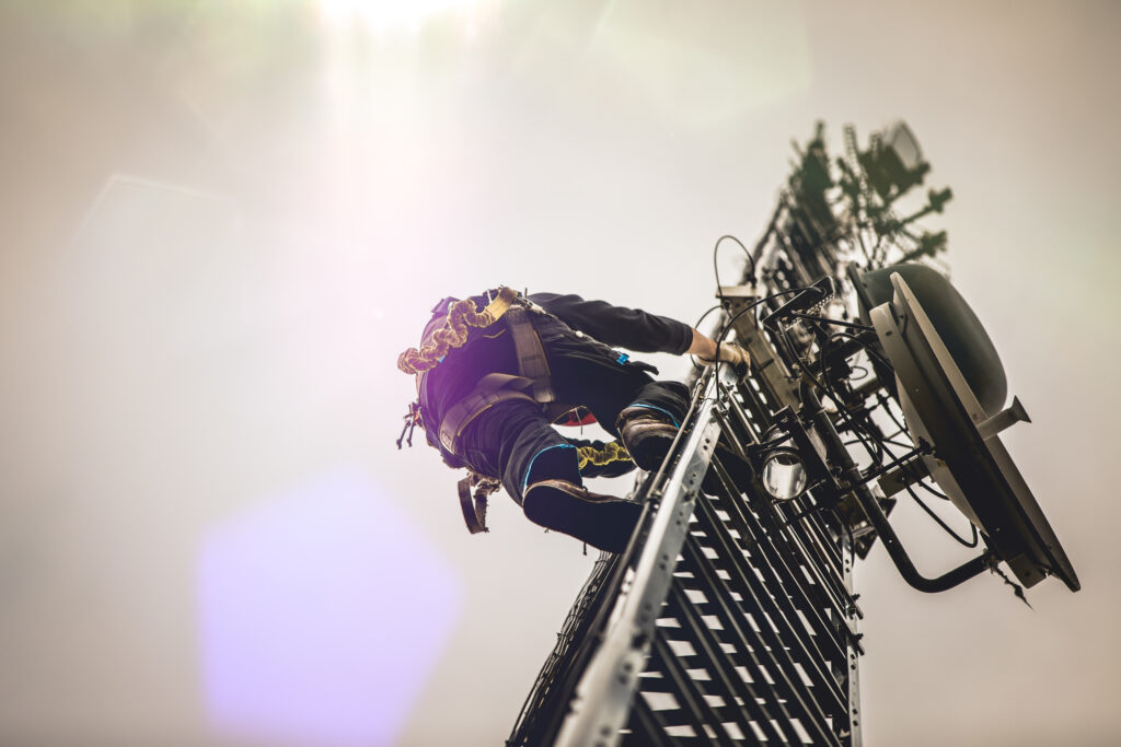 OSHA regulations for fall protection harnesses. Telecom Worker Climbing Antenna Tower