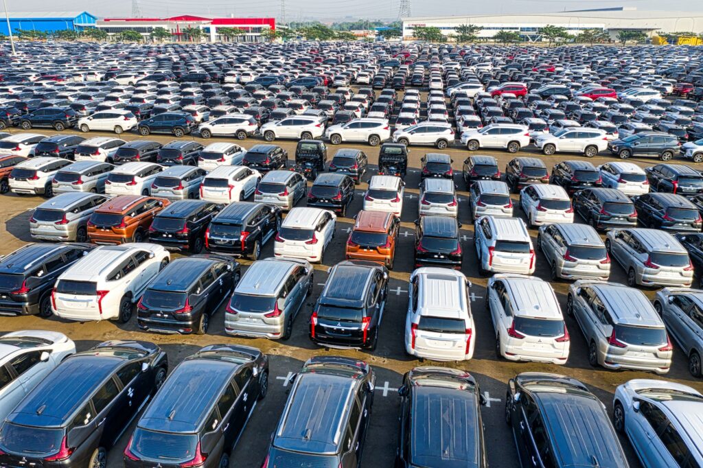 Quality control. From above of rows with many modern new shiny automobiles of contemporary industry in daytime