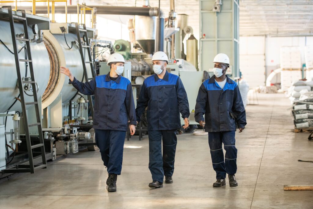 three industrial workers in protective clothing