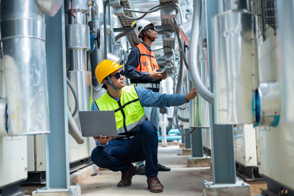 two engineers inspect large aircon units