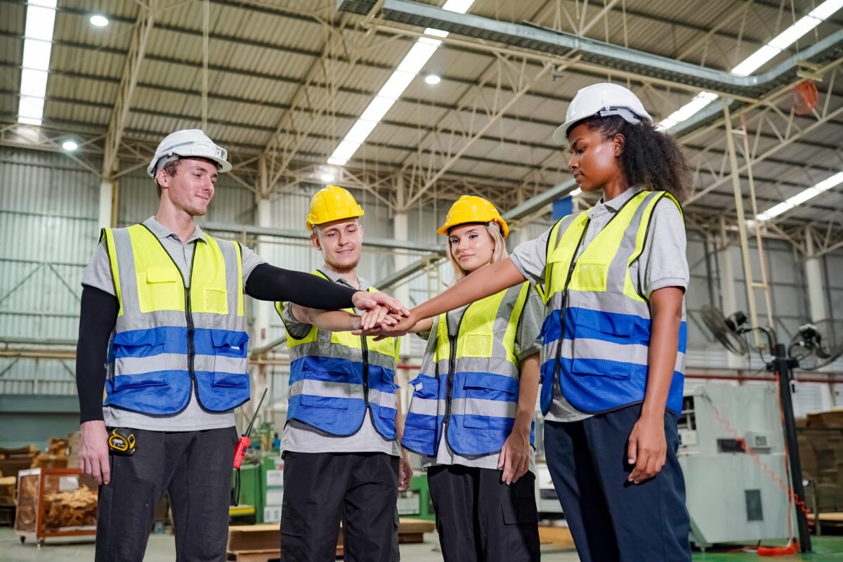 group of smiling workers do hands-in