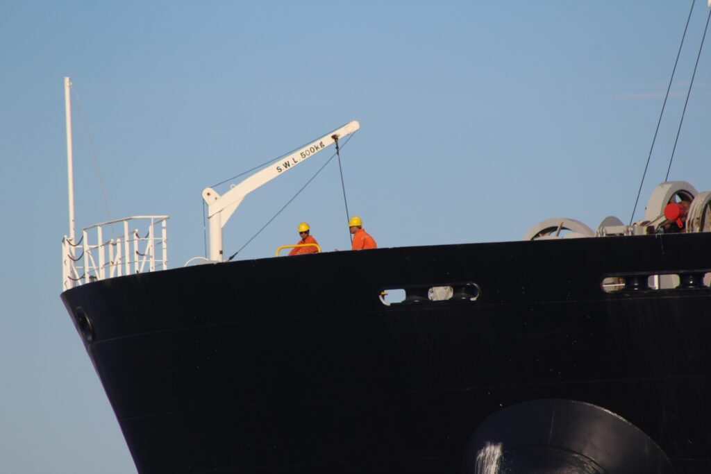 two workers standing on ship