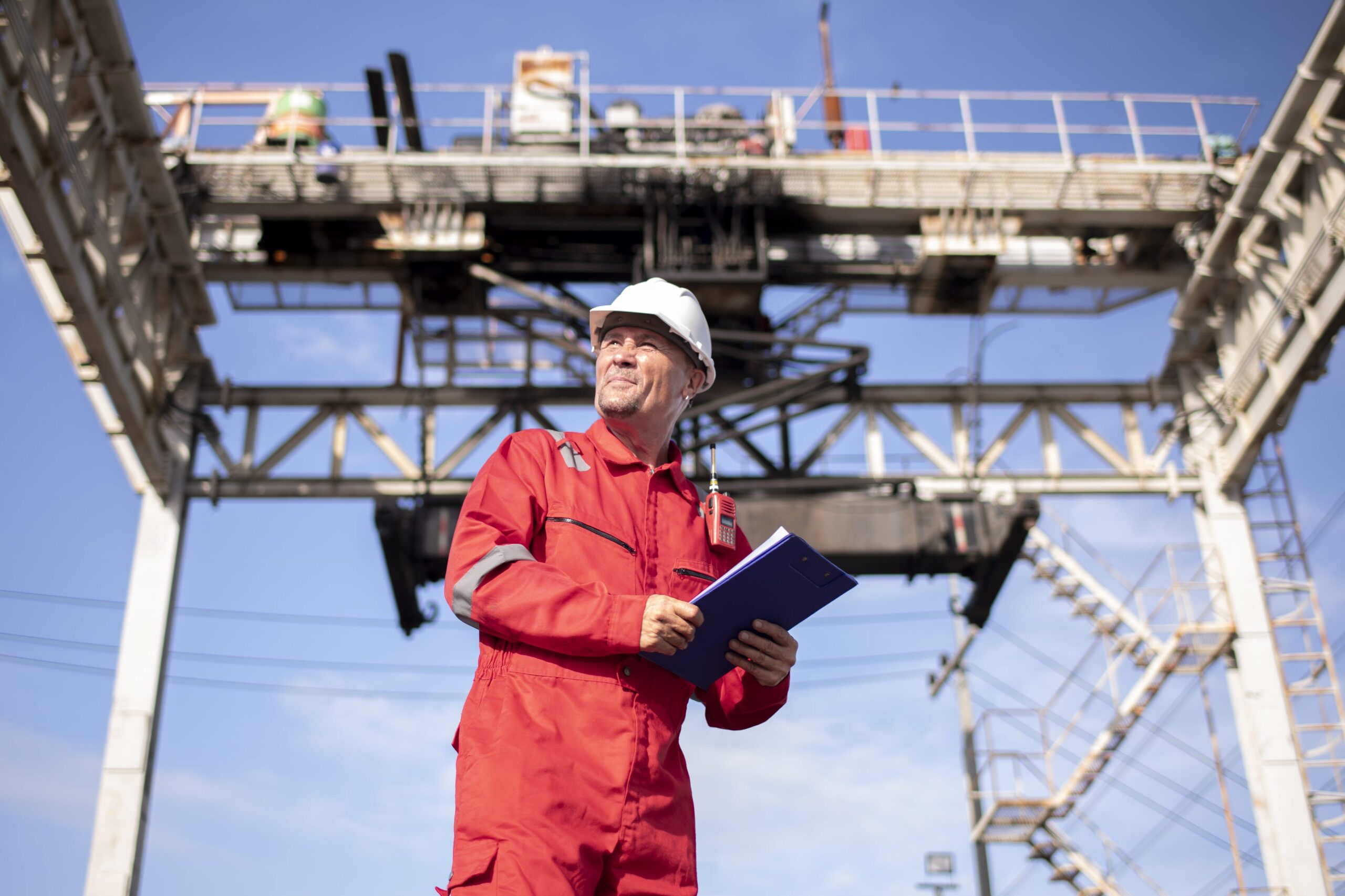 scaffoldd behind engineer in protective clothing holding clipboard