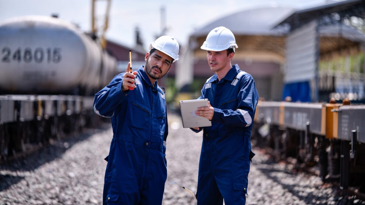 two engineers with tablet inspecting outdoor site